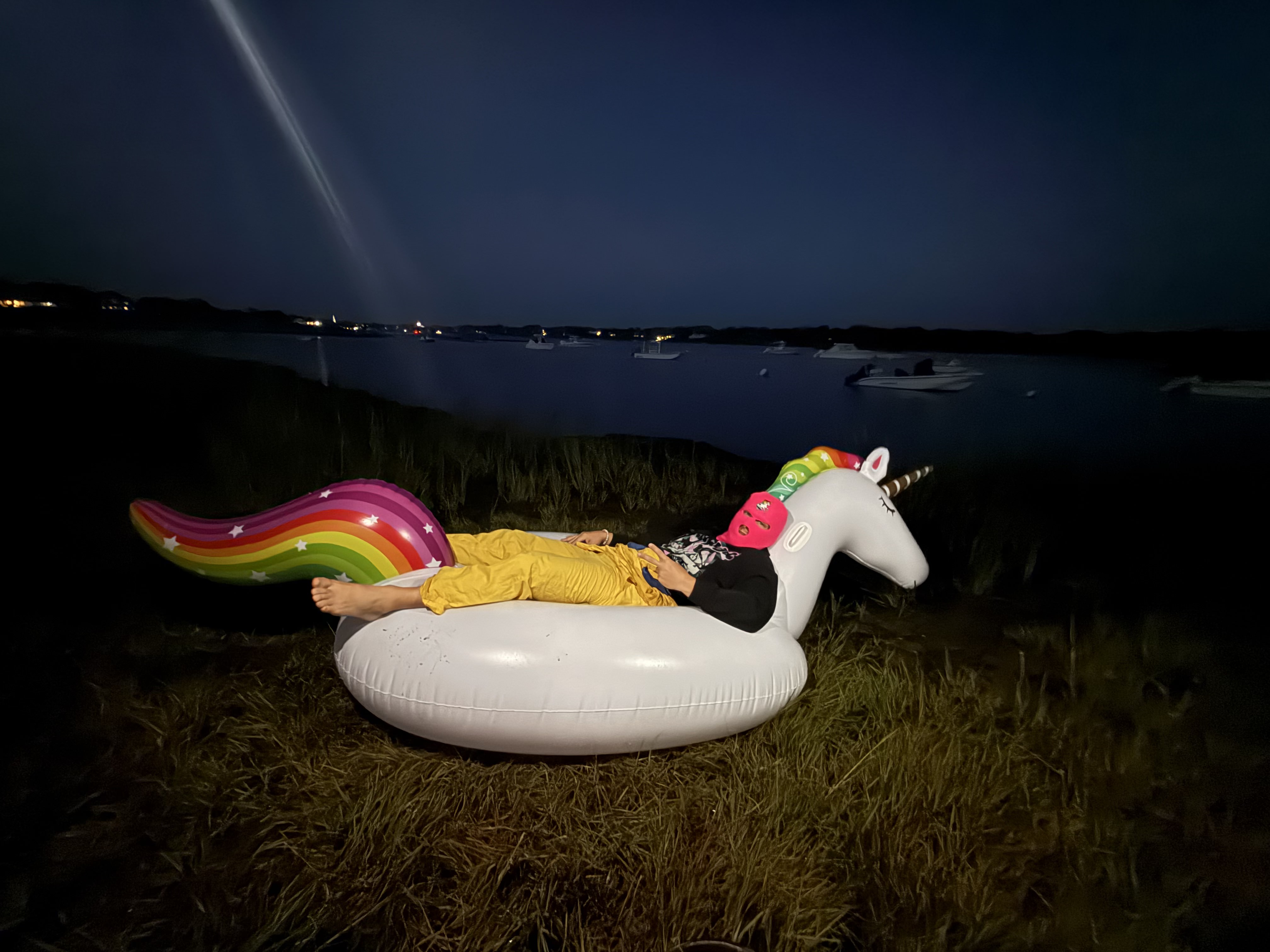UNICORNY at rest on an inflatable unicorn